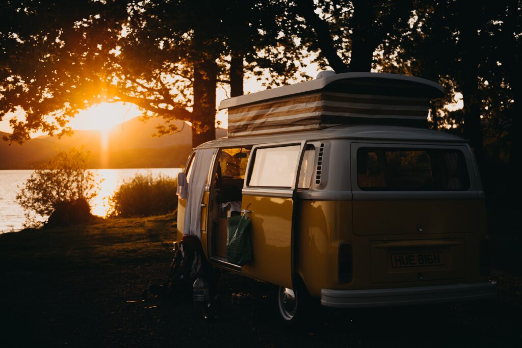 Campervan at sunset, by a lake